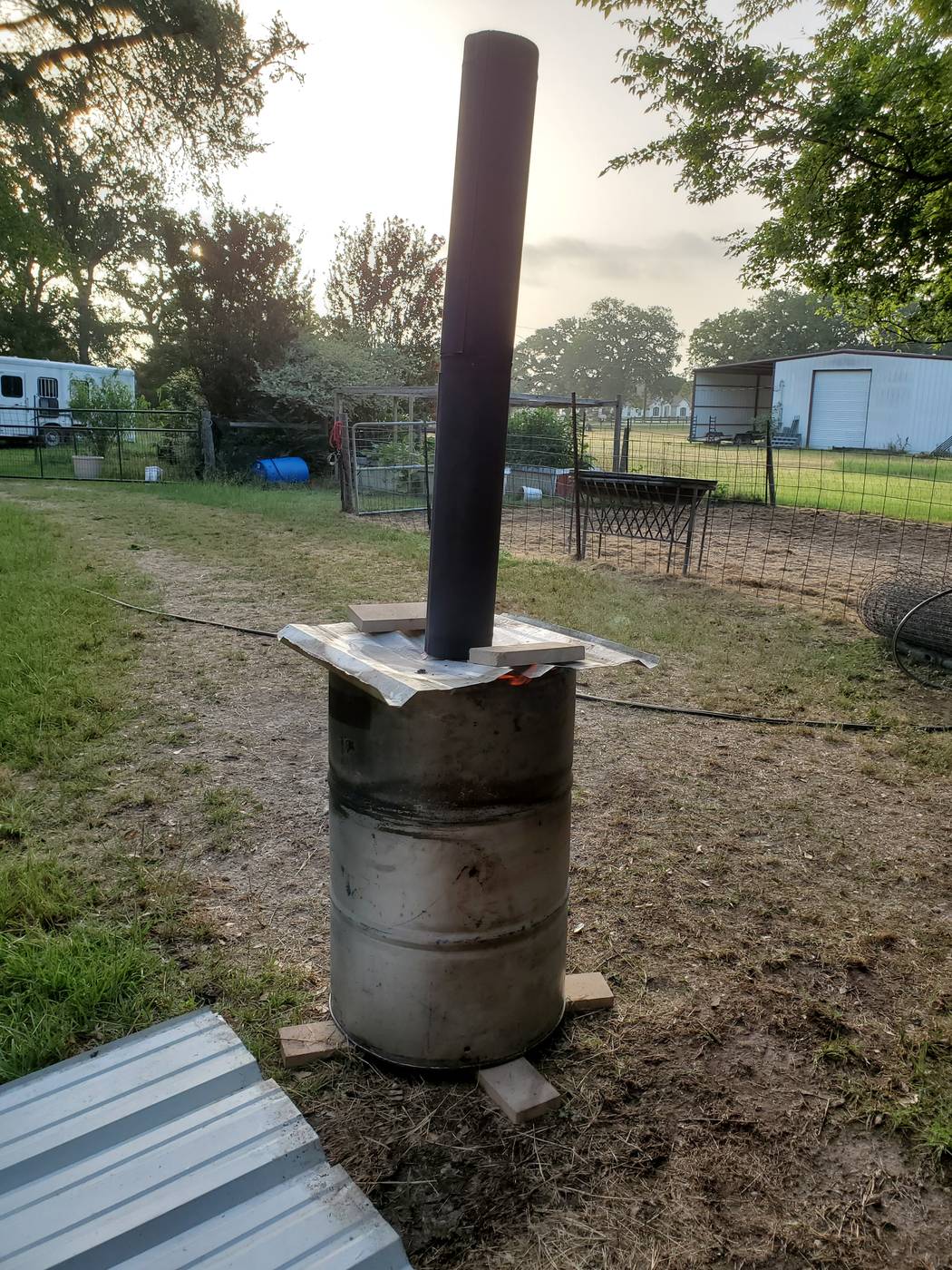 Biochar production with burning stack visible