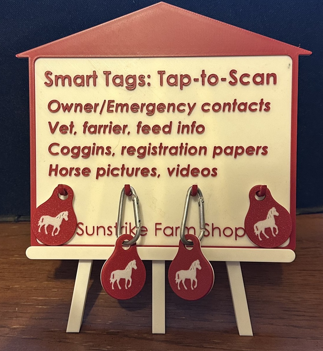 Sunstrike Farm Shop sign for Smart Tags: Tap-to-Scan, listing owner and emergency contacts, vet and farrier info, Coggins and registration papers, horse pictures and videos, with sample tags hanging from the sign